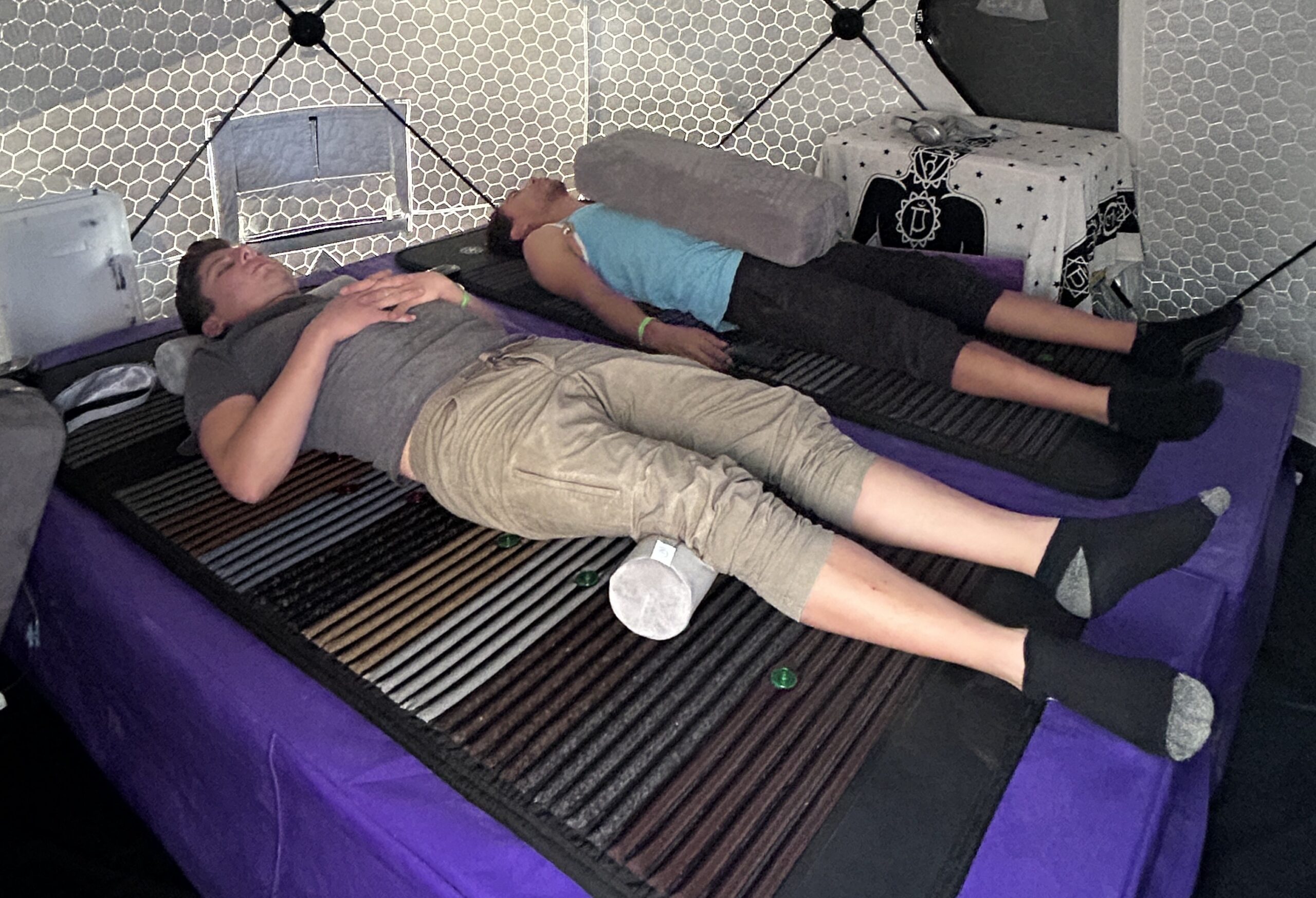 Participants experiencing a VAVE™ Multisensory Resonant Frequency Therapy session inside Resonant Realm's geodesic dome at Burning Man 2024.