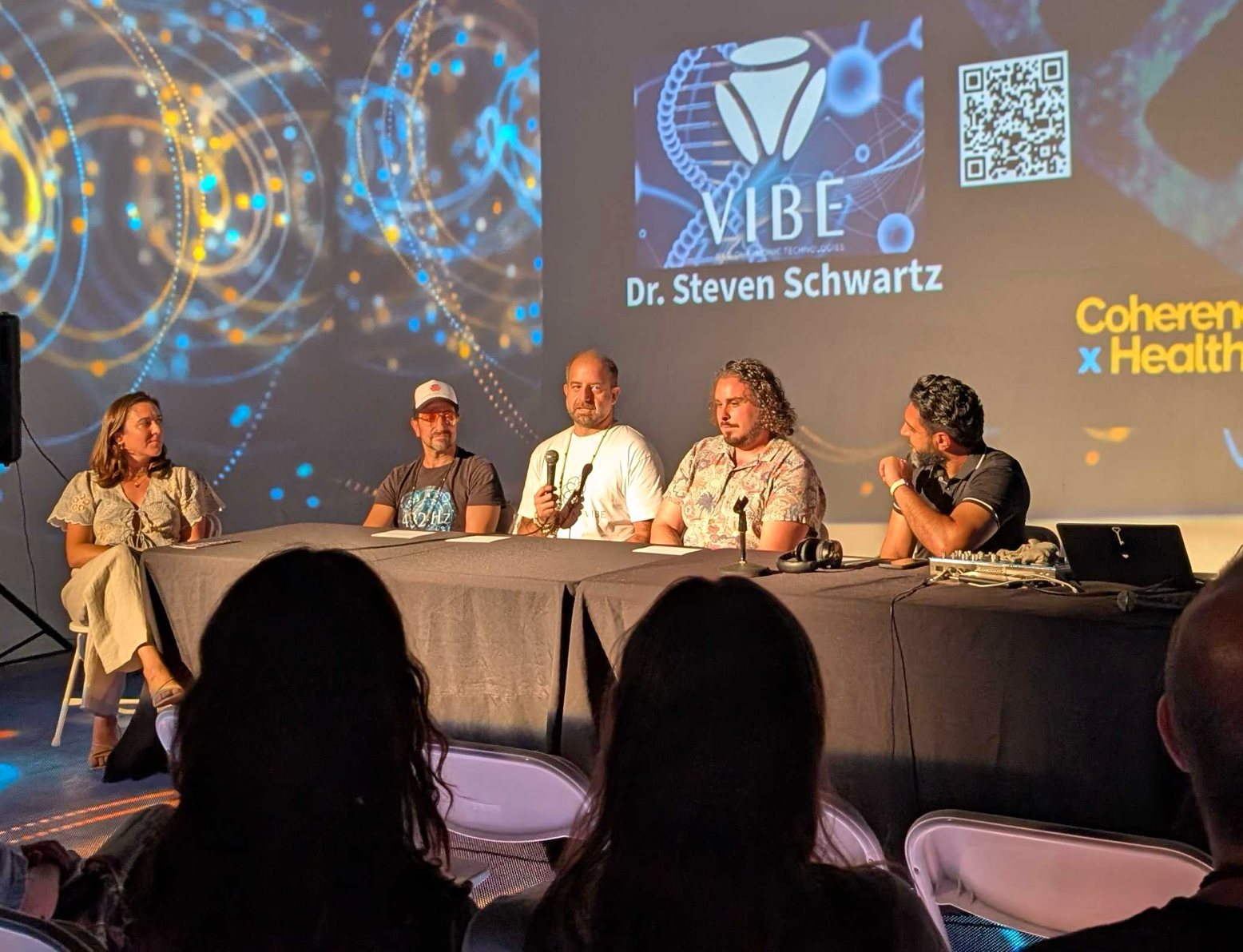 ResonantVibe founder Kaveh Ershadi speaking on a panel about vibroacoustic technology at the Coherence X Health event in Los Angeles in August 2025.