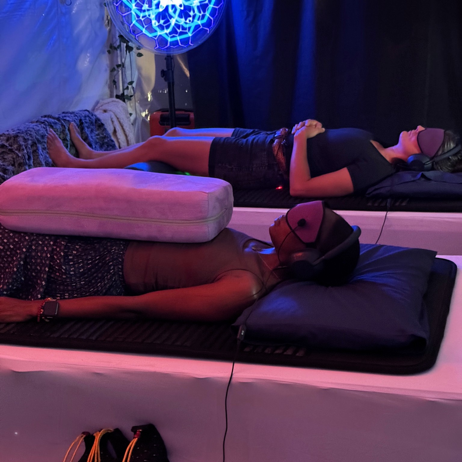 Two participants lying on VAVE™ beds experiencing a Multisensory Resonant Frequency Therapy demo session inside the PORTAL Dome at the MAPS Psychedelic Science Conference.
