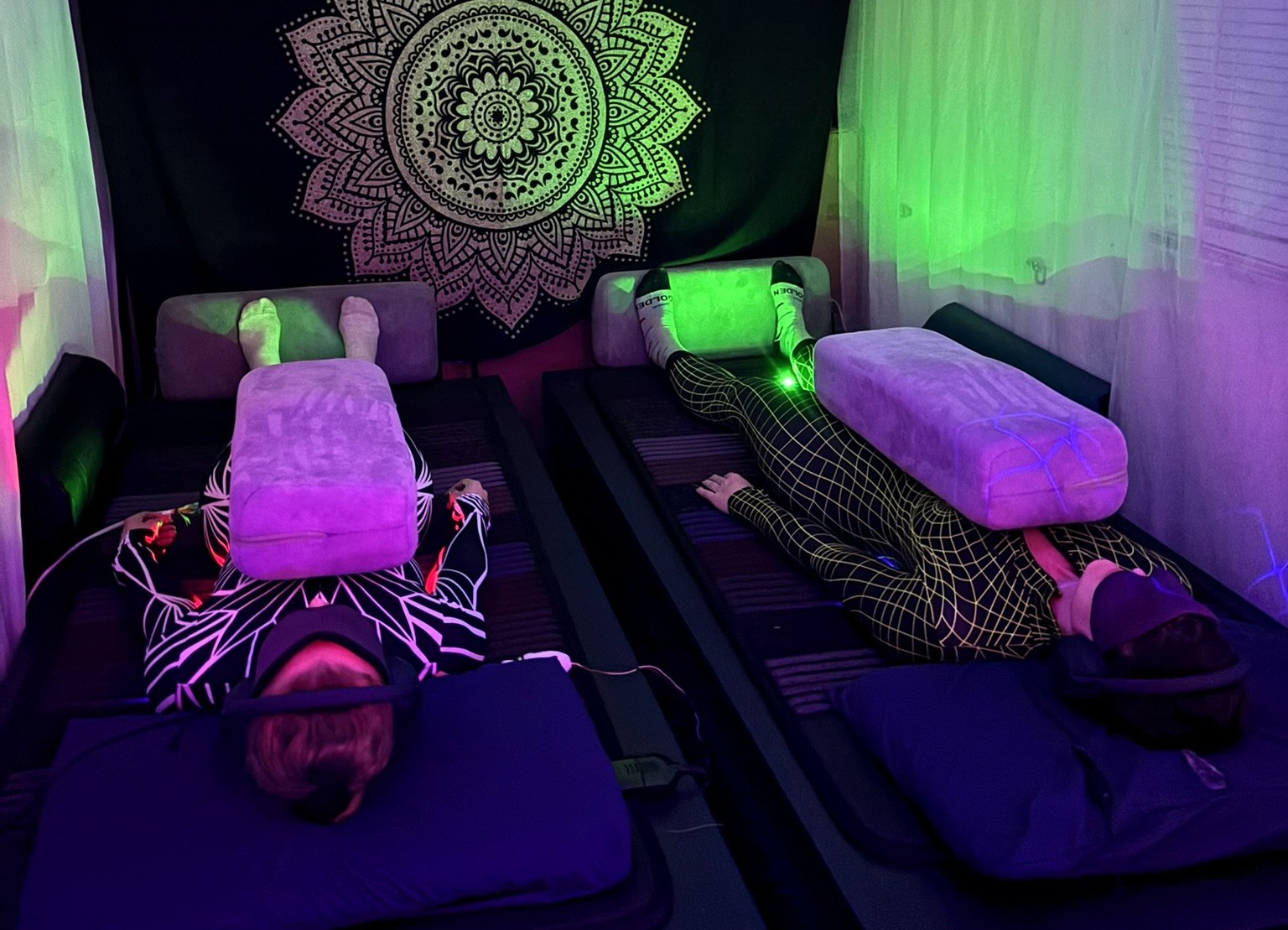 Two participants lying on VAVE™ beds experiencing a Multisensory Resonant Frequency Therapy session inside the Topaz Healing Sanctuary at Gem & Jam Festival 2026.