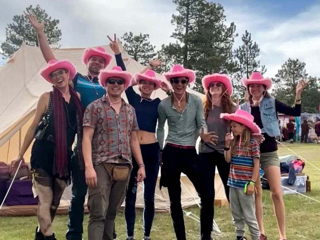 Members of the ResonantVibe team posing together at the Resonant Realm camp during the Elsewhence Burning Man Decompression campout in Pine, Colorado.
