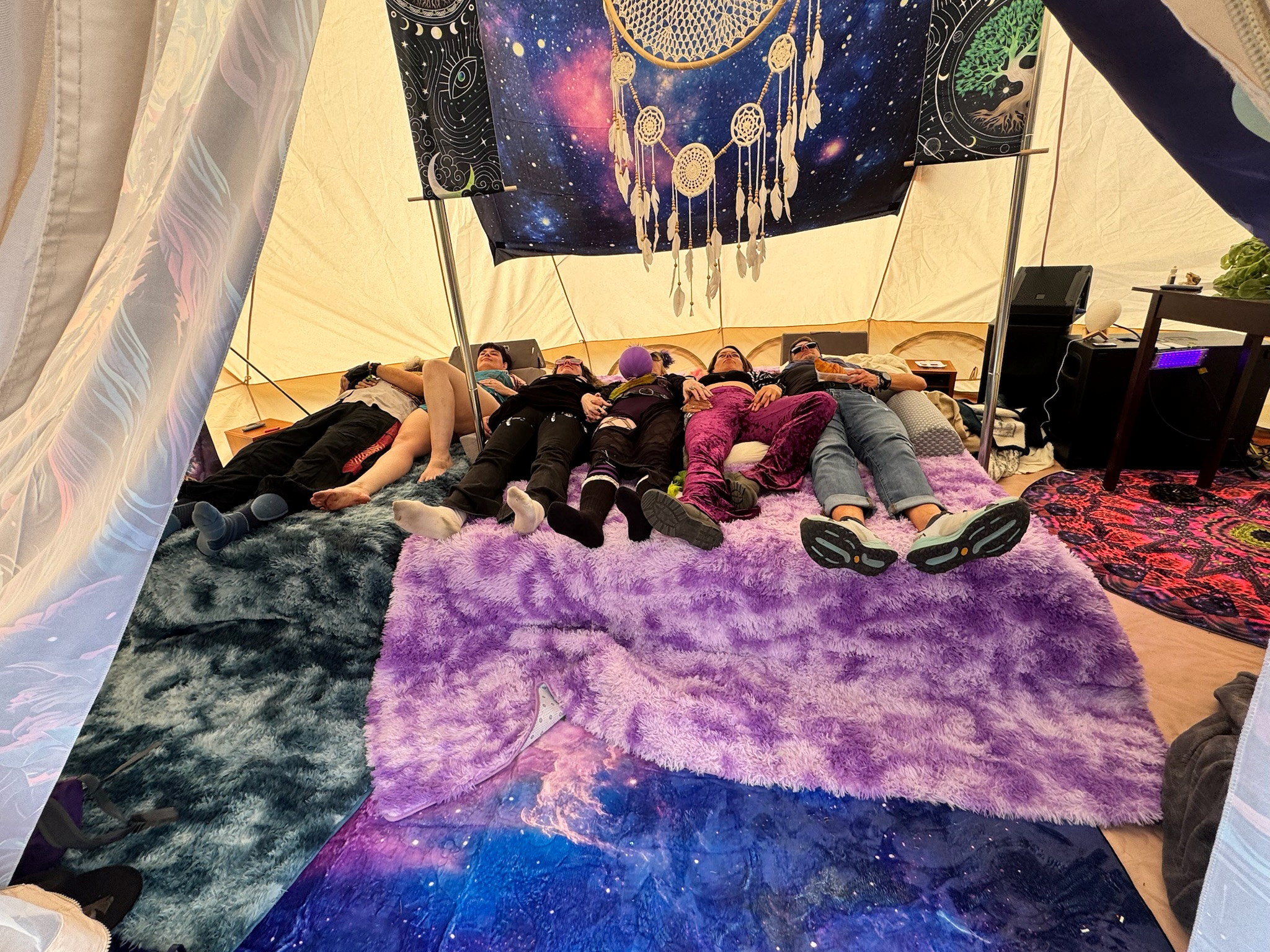 Participants experiencing a VAVE™ Multisensory Resonant Frequency Therapy session inside the ResonantVibe tent at the Elsewhence Burning Man Decompression campout in Pine, Colorado.